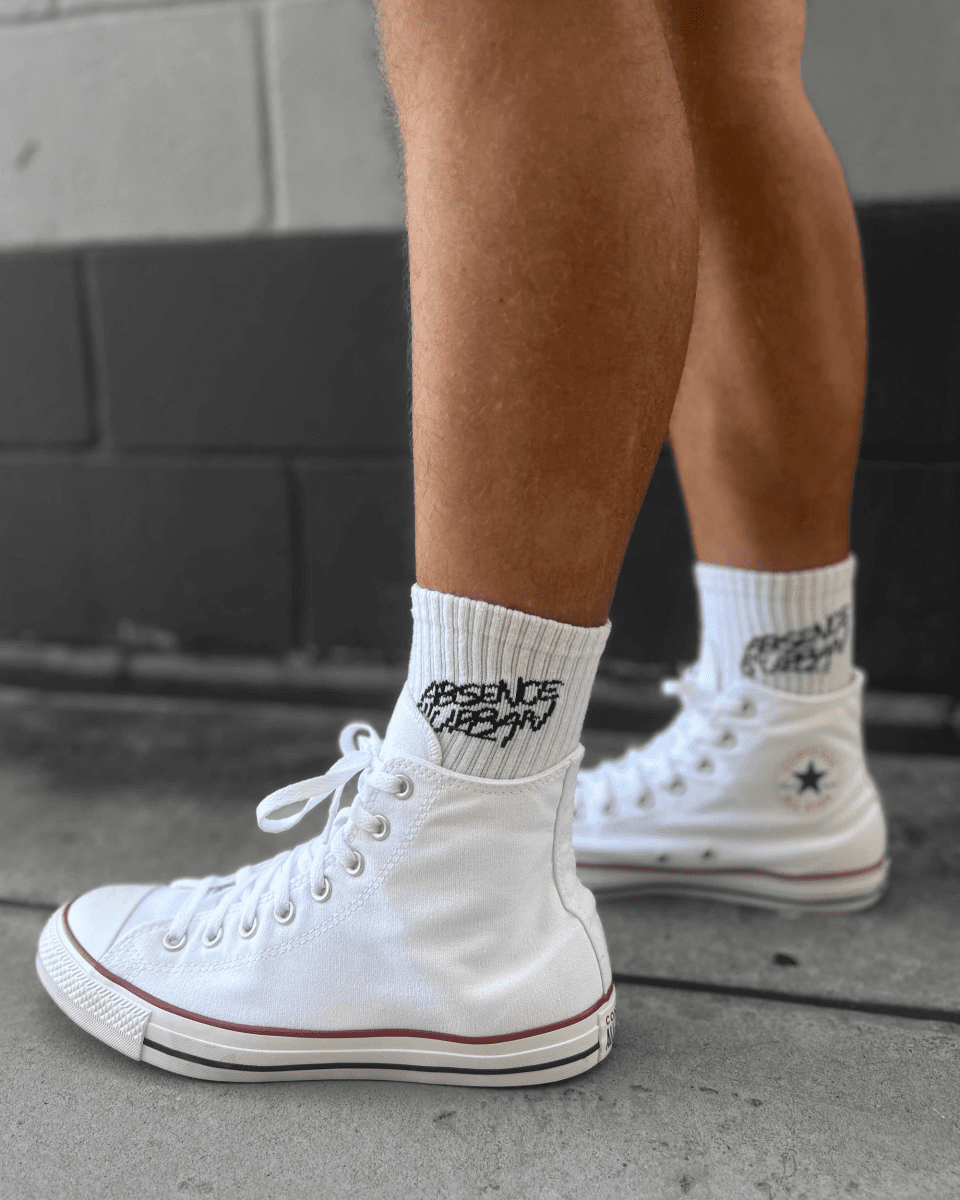 Absenceofurban crew sock made of soft fabric, featuring a classic design with ribbed cuff and logo details.
